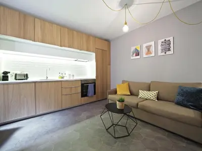 a living room with a couch and a kitchen at Torrassa Cozy Apartment by Olala Homes in Hospitalet de Llobregat