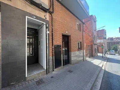 an open door of a brick building on a street at Torrassa Cozy Apartment by Olala Homes in Hospitalet de Llobregat