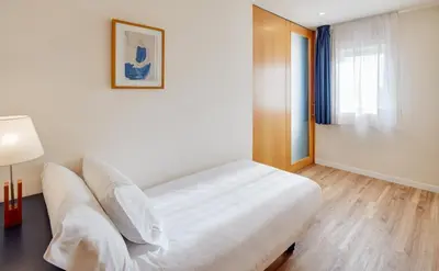a hotel room with a bed and a window at Sercotel Arrahona Sabadell in Sabadell