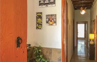 a hallway of a house with paintings on the wall at Lovely Apartment In Pineda De Mar in Pineda de Mar