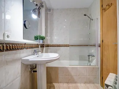 a bathroom with a sink and a shower at Parellades Apartment by Hello Homes Sitges in Sitges