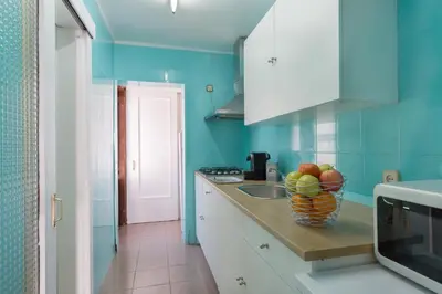 a kitchen with a bowl of fruit on a counter at Vilasardemarlux1 in Vilassar de Mar