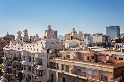 a view of the roofs of buildings in a city at Sweett - Pedrera Department 24 in Barcelona
