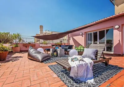 a patio with a bench and a table on a patio at Sweett - Pedrera Department 24 in Barcelona