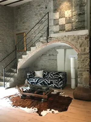 a living room with a couch and a staircase at Hostal Sant Roc in Montseny