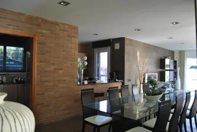 a dining room with a glass table and chairs at Can Vinyals Holiday Home in Castellar