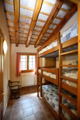 a room with two bunk beds and a window at Entre Roures in Moià