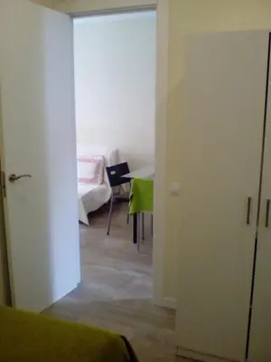a bedroom with two beds and a window at Castel Apartments in Hospitalet de Llobregat