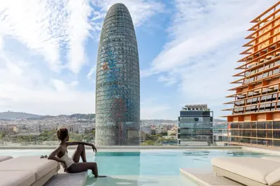 a pool on the roof of a building with a skyscraper at Hotel SB Glow 4 Sup in Barcelona