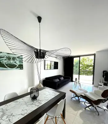 a living room with a chandelier hanging from the ceiling at Vivalidays Yolanda in Calella