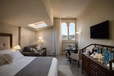 a hotel room with a bed and a living room at Hotel Casa Vilella 4* Sup in Sitges