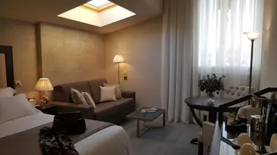 a hotel room with a bed and a couch at Hotel Casa Vilella 4* Sup in Sitges