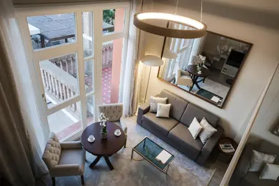 a living room with a couch and a table at Hotel Casa Vilella 4* Sup in Sitges