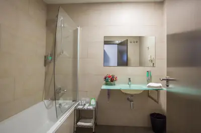 a bathroom with a shower and a sink and a tub at Hotel Venture Sant Cugat in Sant Cugat del Vallès