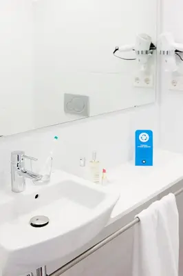 a white bathroom with a sink and a mirror at Live & Dream in Barcelona