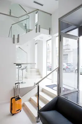 a living room with a staircase and a yellow suitcase at Live & Dream in Barcelona