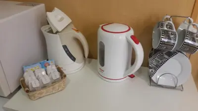 a kitchen counter with two coffee makers and a blender at Hostal BESTPRICE Barcelona Stadium in Barcelona
