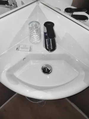 a white bathroom sink with a soap dispenser on it at Hostal BESTPRICE Barcelona Stadium in Barcelona