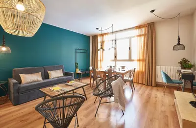 a living room with a couch and a table at Barcelona Sants Station Apartments in Barcelona