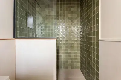 a bathroom with a shower with green tiles at Unique Rentals - Luxurious Oasis in Barcelona