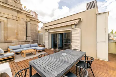 a patio with a table and chairs and a couch at Unique Rentals - Placa Catalunya Central Apartments in Barcelona