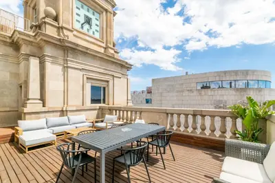 a patio with a table and chairs on a balcony at Unique Rentals - Placa Catalunya Central Apartments in Barcelona