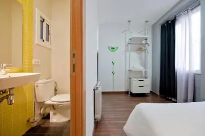 a bathroom with a sink and a toilet and a sink at Hostal Nitzs Bcn in Barcelona
