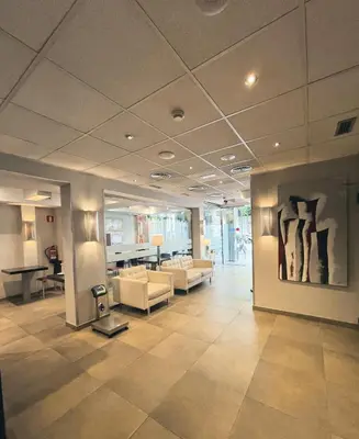 a lobby with couches and a painting on the wall at SM Hotel Sant Antoni in Barcelona