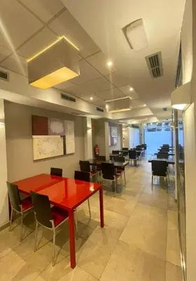 a dining room with a red table and chairs at SM Hotel Sant Antoni in Barcelona