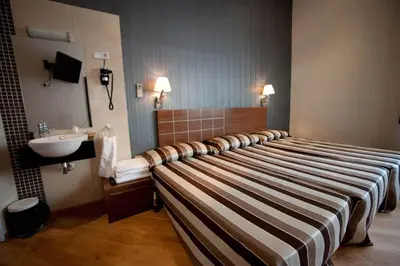 a hotel room with a bed and a sink at Hostal Bcn 46 in Barcelona