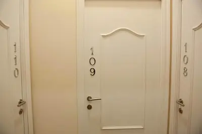 a white door with numbers on it in a hallway at Hostal Bcn 46 in Barcelona