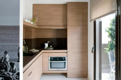 a kitchen with wooden cabinets and a stove at Eric Vökel Boutique Apartments - BCN Suites in Barcelona