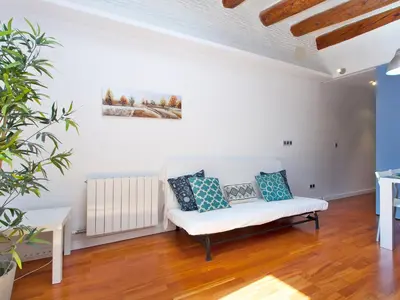 a living room with a white couch and a table at Barcelona Igualada Apartment in Barcelona