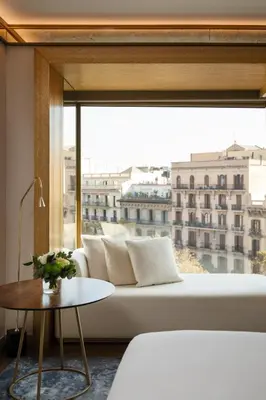 a living room with a white couch and a large window at Almanac Barcelona in Barcelona