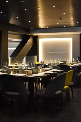 a dining room with tables and chairs with wine glasses at Almanac Barcelona in Barcelona