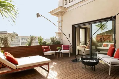 a patio with chairs and tables on a building at Almanac Barcelona in Barcelona