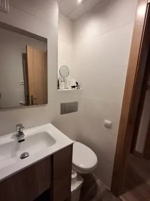 a bathroom with a sink and a toilet and a mirror at Candela's Beach Port in Masnou