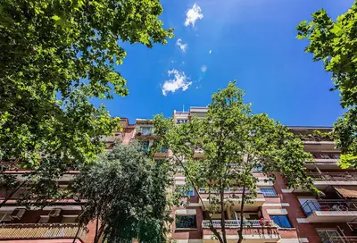 a tall building with trees in front of it at Sweett - Wellington in Barcelona