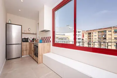 a kitchen with a large window and a refrigerator at Sweett - Wellington in Barcelona