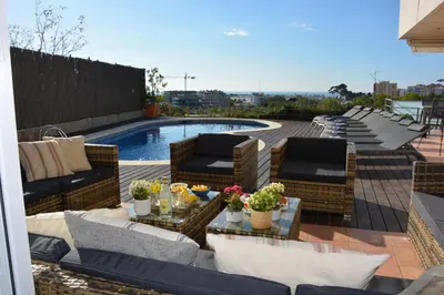 a patio with wicker furniture and a swimming pool at Villa Med A 2 kilometros andando de la playa, del puerto de Aguadoç y a 4 del centro de Sitges Muy Soleada todo el dia Capacidad superior a 16 personas NO REQUIERE COCHE in Sitges