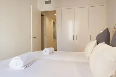 a bedroom with a white bed with towels on it at Canela Homes BARCELONA MACBA in Barcelona