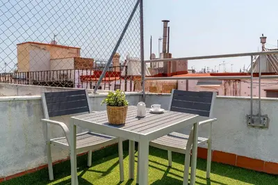 a table and chairs on top of a balcony at Canela Homes BARCELONA MACBA in Barcelona