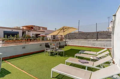 a patio with chairs and a table on a roof at Canela Homes BARCELONA MACBA in Barcelona