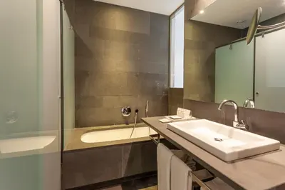 a bathroom with a sink and a shower at Suites Avenue in Barcelona