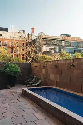 a swimming pool on the roof of a building at Suites Avenue in Barcelona