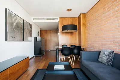 a living room with a couch and a brick wall at Suites Avenue in Barcelona