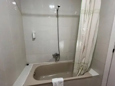 a bathroom with a bath tub with a shower curtain at Cuatro Naciones in Barcelona