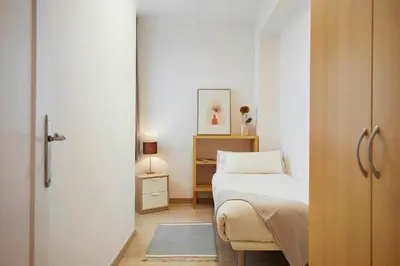 a small bedroom with a bed and a closet at Fisa Rentals Aribau in Barcelona