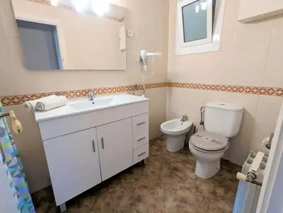 a kitchen with a sink and a refrigerator at Spacious apartment in Cabrera de Mar with sea view in Cabrera de Mar