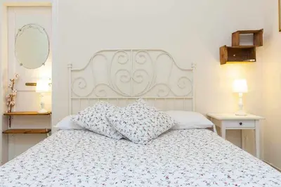 a white bed with two pillows on top of it at Cal Mateu 11 huéspedes - Sagrada Família in Barcelona